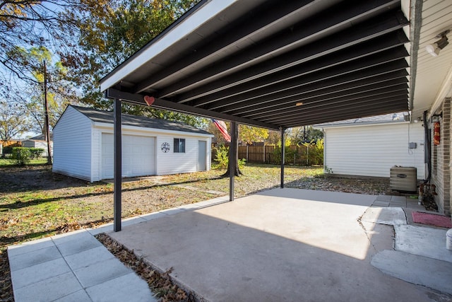 view of patio / terrace featuring a garage and an outbuilding