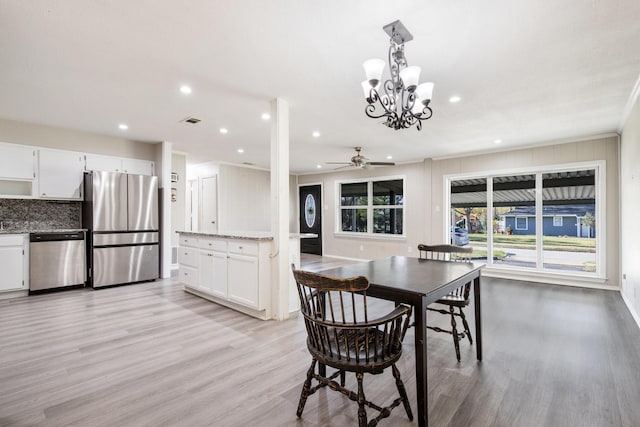 dining area featuring ornamental molding, ceiling fan, and light wood-type flooring