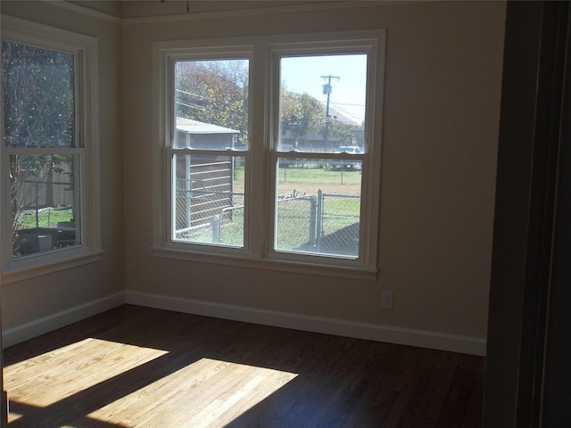 unfurnished room with dark hardwood / wood-style flooring