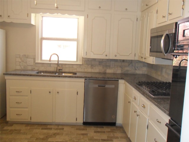 kitchen featuring white cabinetry, stainless steel appliances, sink, and tasteful backsplash