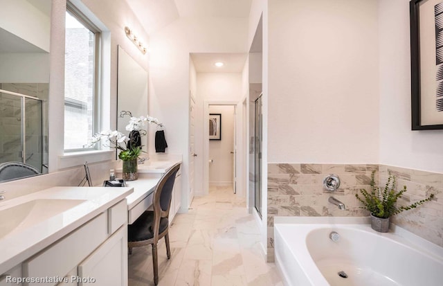 full bathroom featuring vanity, a garden tub, a stall shower, and marble finish floor