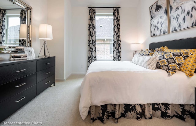 bedroom featuring multiple windows, light carpet, and baseboards