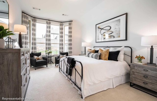 bedroom with light carpet and visible vents