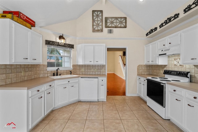 kitchen with sink, light tile patterned floors, high vaulted ceiling, white appliances, and white cabinets