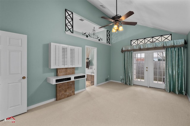 carpeted living room with french doors, high vaulted ceiling, and ceiling fan