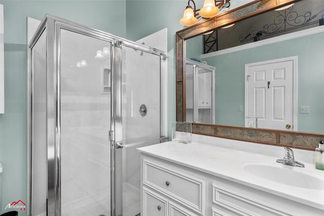 bathroom featuring vanity and a shower with shower door