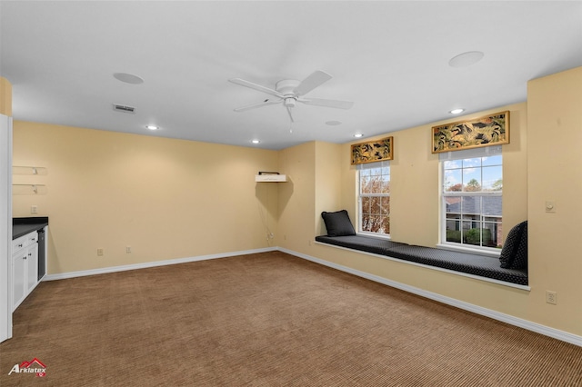 unfurnished room featuring ceiling fan and carpet