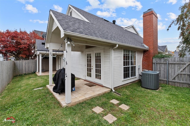 back of property featuring a lawn, central AC, french doors, and a patio