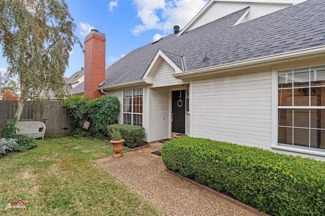 property entrance with a lawn