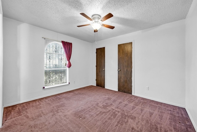 unfurnished bedroom with carpet flooring, ceiling fan, and a textured ceiling