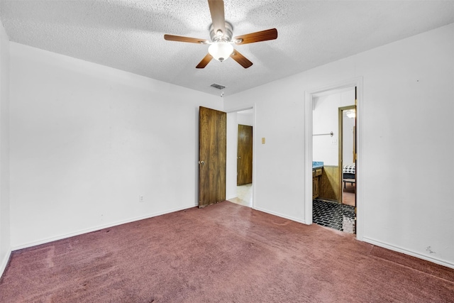 unfurnished bedroom with carpet flooring, ceiling fan, and a textured ceiling