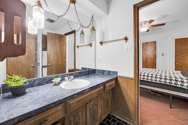 bathroom featuring vanity, a textured ceiling, and ceiling fan