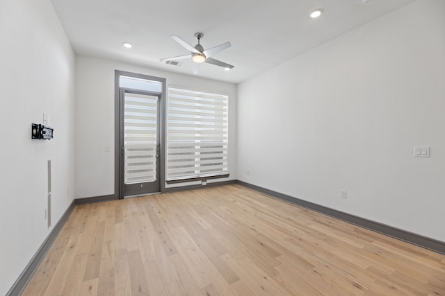 empty room featuring ceiling fan and light wood-type flooring