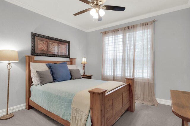 bedroom featuring ornamental molding, light colored carpet, ceiling fan, and a tray ceiling