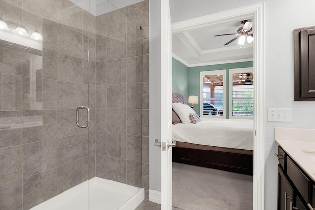 bathroom with ornamental molding, vanity, ceiling fan, and walk in shower