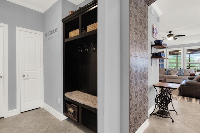 bathroom with ornamental molding, tile patterned floors, vanity, and a tile shower