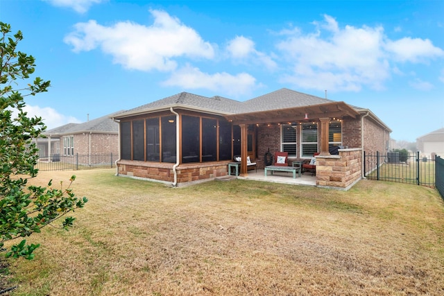 back of house with a patio, a sunroom, and a lawn