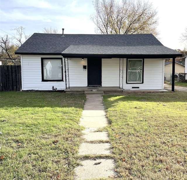 ranch-style home with covered porch and a front yard