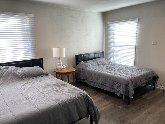 bedroom with dark hardwood / wood-style floors