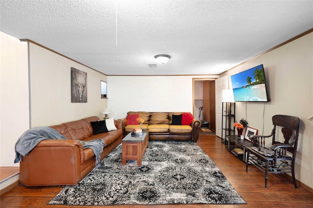 living room featuring ornamental molding, a textured ceiling, and hardwood / wood-style flooring