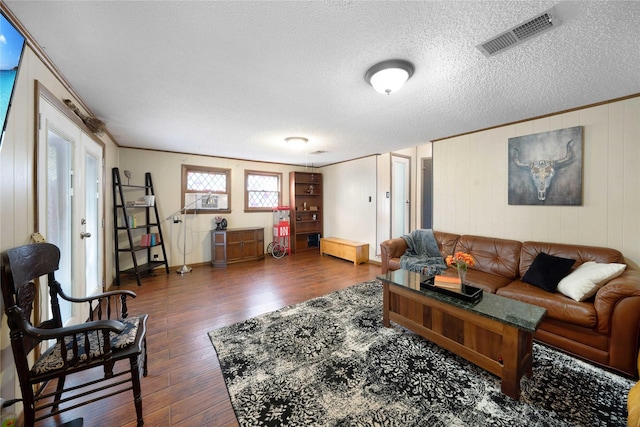 living room with a textured ceiling and dark wood-type flooring