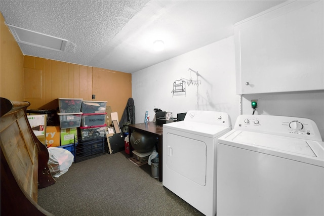 laundry room featuring dark carpet, cabinets, separate washer and dryer, and a textured ceiling