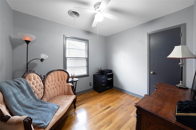 sitting room featuring ceiling fan and light hardwood / wood-style flooring