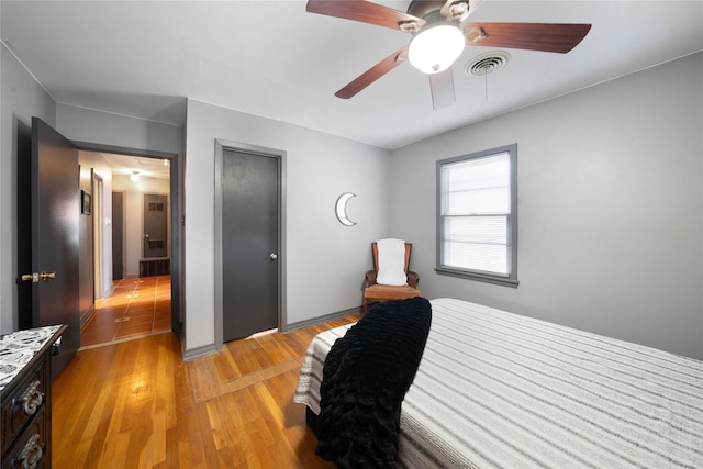 bedroom with ceiling fan and light wood-type flooring