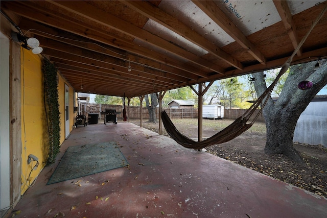 view of patio featuring grilling area and a storage unit