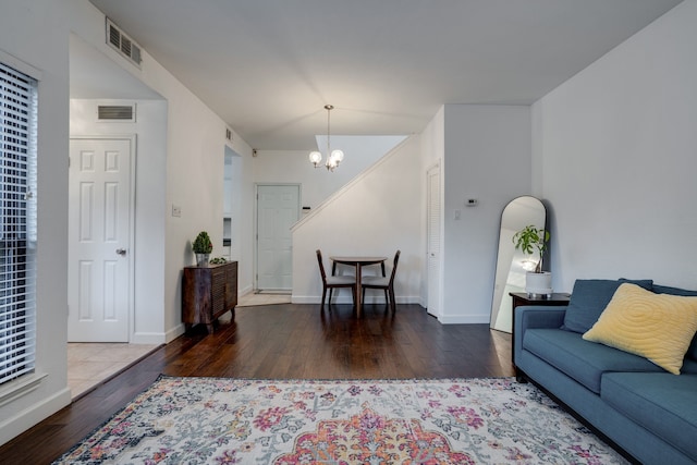 living room featuring dark wood-type flooring and a notable chandelier