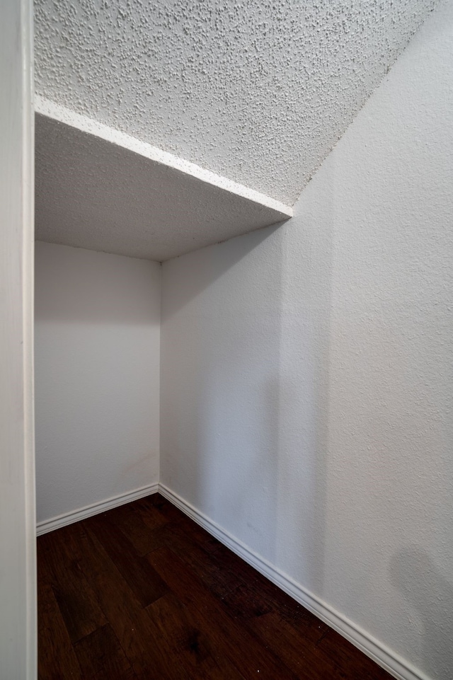 empty room featuring dark hardwood / wood-style flooring