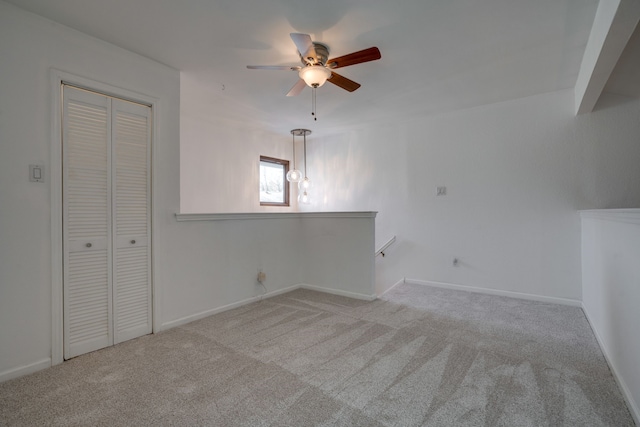 empty room with light colored carpet and ceiling fan