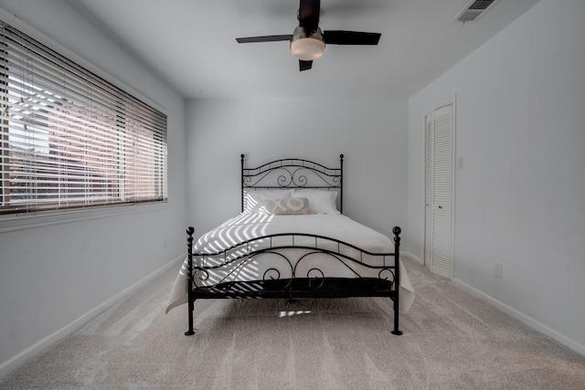 carpeted bedroom with a closet and ceiling fan