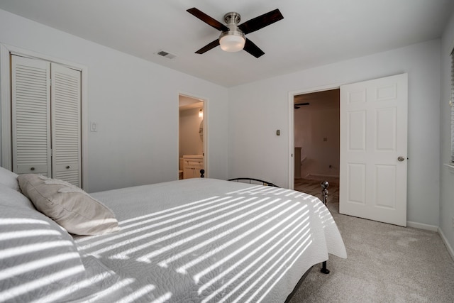 carpeted bedroom featuring connected bathroom, ceiling fan, and a closet