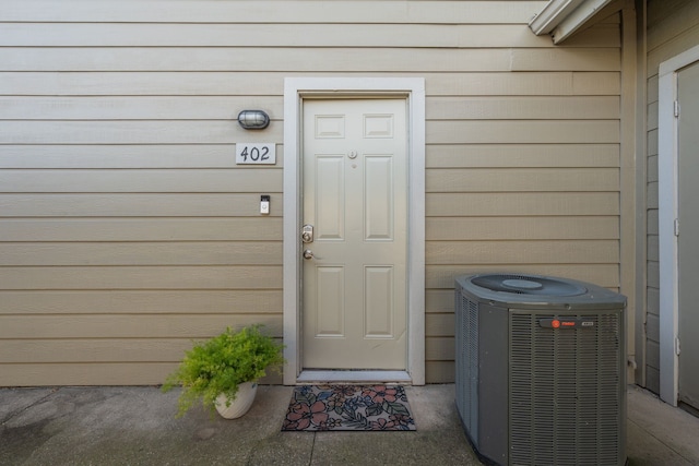 entrance to property featuring cooling unit