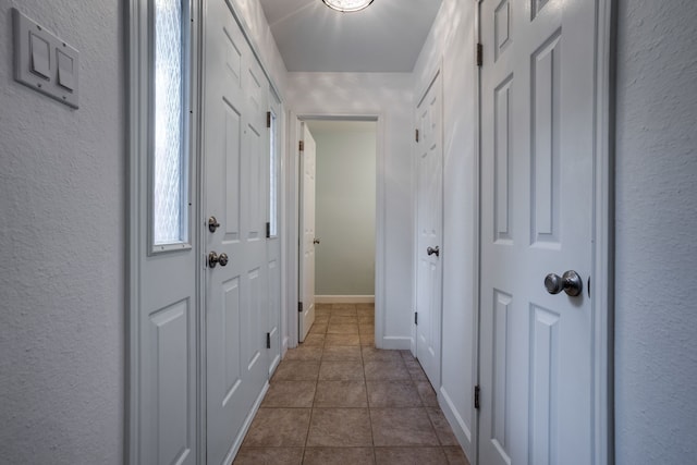 doorway featuring dark tile patterned floors