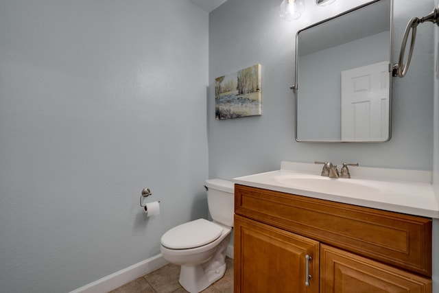 bathroom featuring tile patterned floors, vanity, and toilet