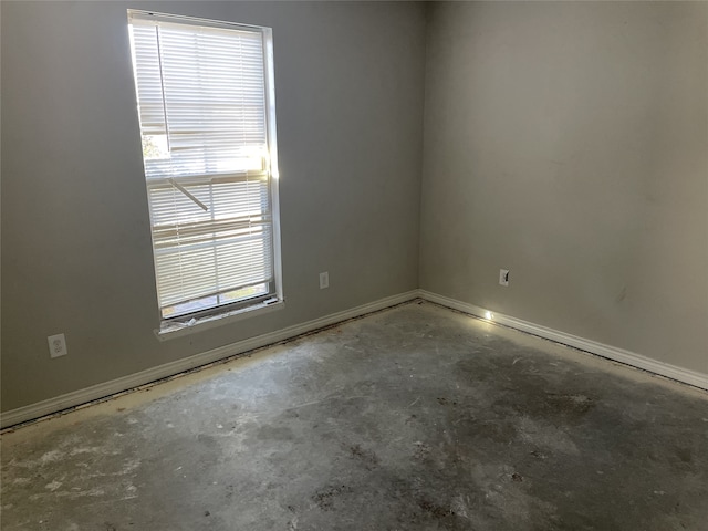 unfurnished room featuring plenty of natural light and concrete floors