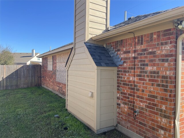 view of side of home featuring a lawn