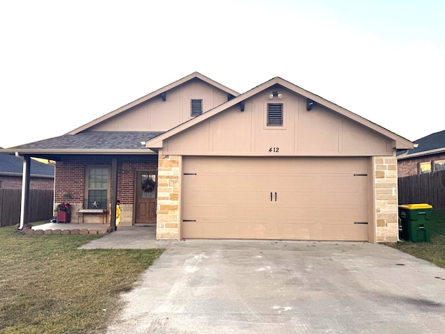 view of front of property with a porch, a garage, and a front lawn