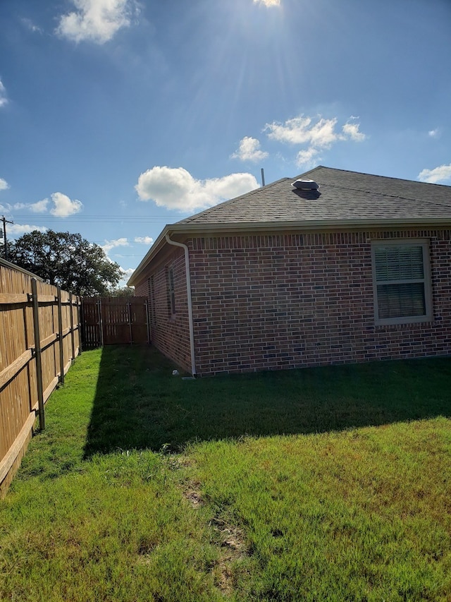 view of side of home featuring a yard