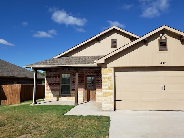 view of front facade with covered porch, a garage, and a front lawn