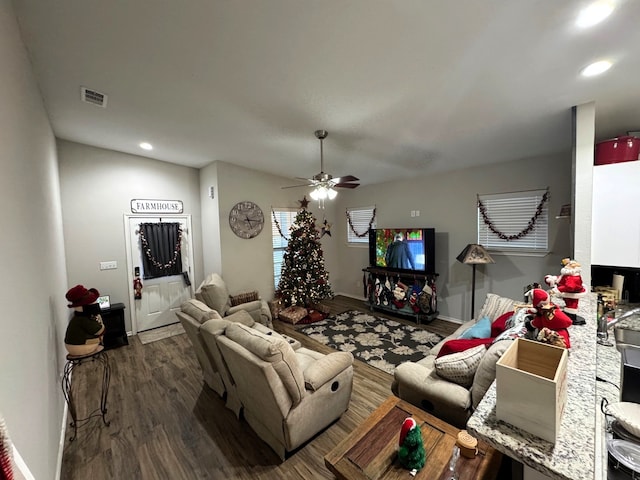 living room featuring ceiling fan and dark hardwood / wood-style flooring