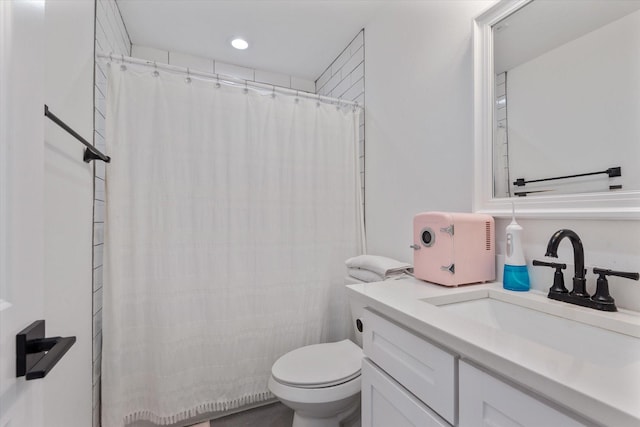 bathroom with vanity, a shower with curtain, and toilet