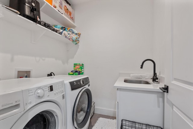 washroom featuring tile patterned flooring, sink, and independent washer and dryer