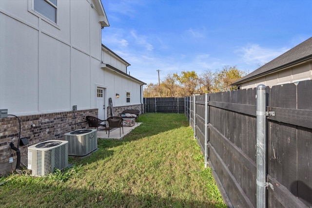 view of yard featuring a patio and central air condition unit