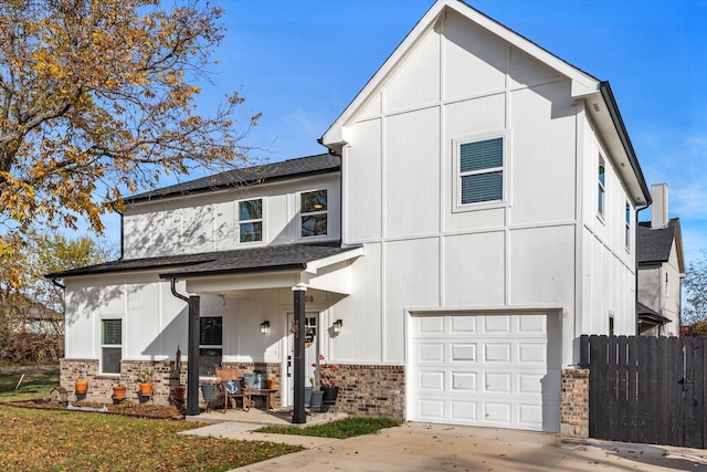 view of front of property featuring covered porch and a garage