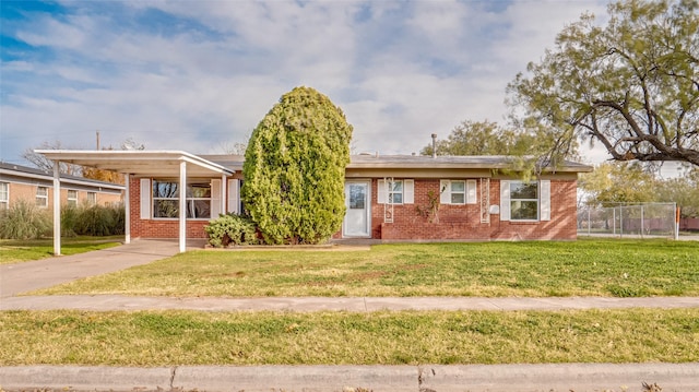 view of front of house with a carport and a front lawn