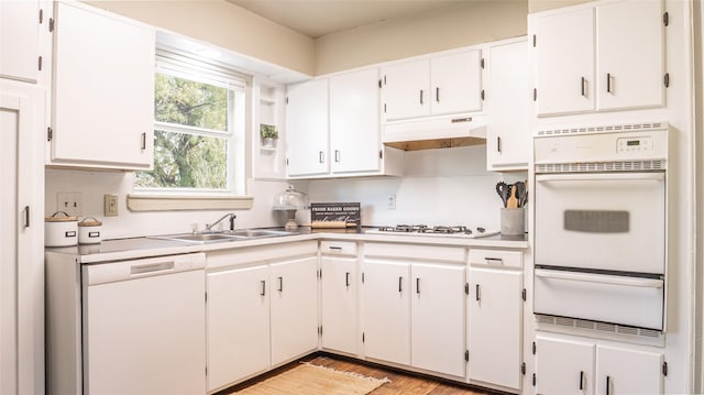 kitchen featuring white cabinets, light wood-type flooring, white appliances, and sink