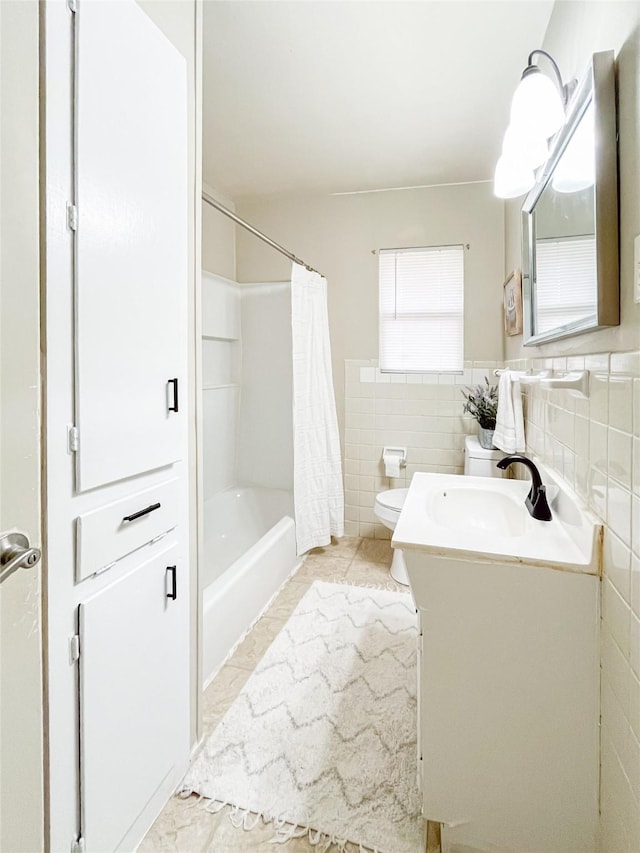 full bathroom with vanity, tile patterned floors, toilet, shower / bathtub combination with curtain, and tile walls